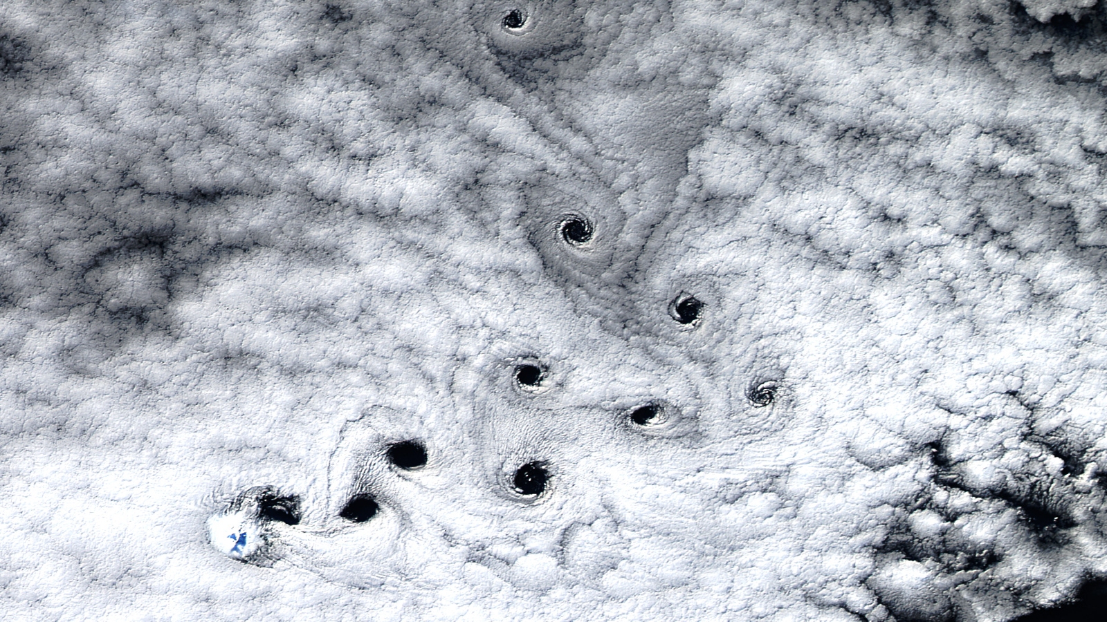 Ten strange “dark voids” appear in the sky above a deserted island near Antarctica – Earth from Space